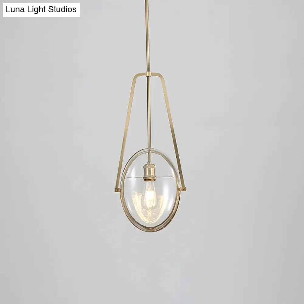 Modern Brass Pendant Light with Clear Glass Shade and Unique Halberd Frame